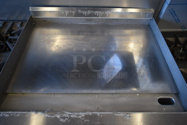 BRAND NEW SCRATCH AND DENT! Garland G60-4G36RR Stainless Steel Commercial Natural Gas Powered 4 Burner Range w/ Flat Top, 2 Ovens, Over Shelf and Back Splash.  - Image 4 of 10