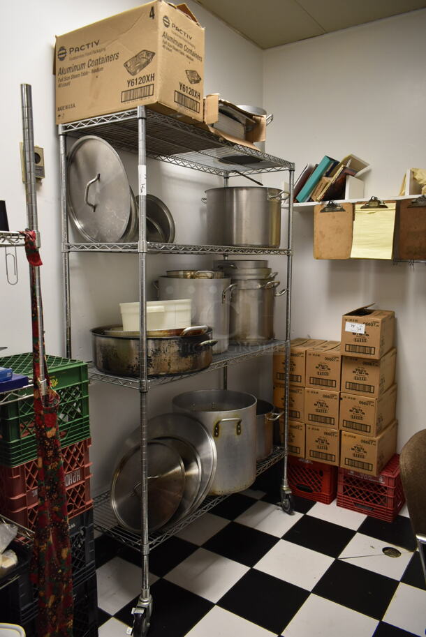 Metro Chrome Finish 4 Tier Wire Shelving Unit w/ Contents Including Metal Stock Pots on Commercial Casters. BUYER MUST REMOVE: BUYER MUST DISMANTLE. PCI CANNOT DISMANTLE FOR SHIPPING. PLEASE CONSIDER FREIGHT CHARGES. (kitchen) - Image 1 of 5