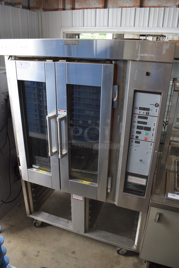 Stainless Steel Commercial Floor Style Natural Gas Powered Mini Rotating Rack Oven w/ Lower Pan Rack on Commercial Casters. Appears To Be Baxter Brand. 48x40x75