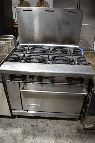 American Range Stainless Steel Commercial Natural Gas Powered 6 Burner Range w/ Oven and Back Splash.