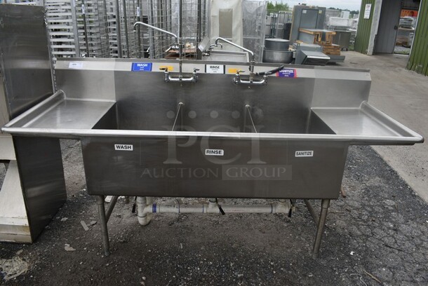 Stainless Steel Commercial 3 Bay Sink w/ Dual Drainboards, 2 Faucets and 2 Handle Sets. 94x34x46. Bays 21x31x18. Drainboards 16x31x2.
