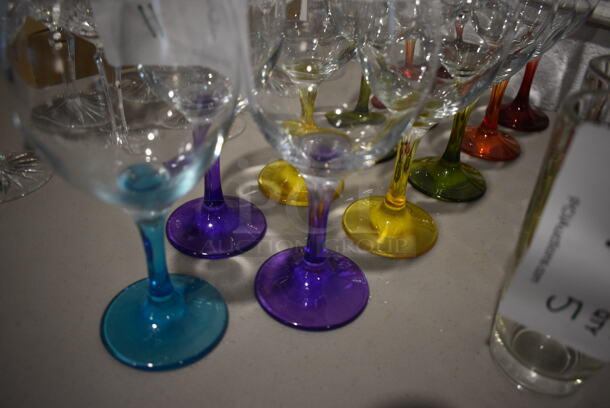 11 Wine Glasses w/ Various Colored Bases; 2 Red, 2 Orange, 2 Green, 2 Yellow, 2 Purple and 1 Blue. 3.5x3.5x7. 11 Times Your Bid! - Image 2 of 3