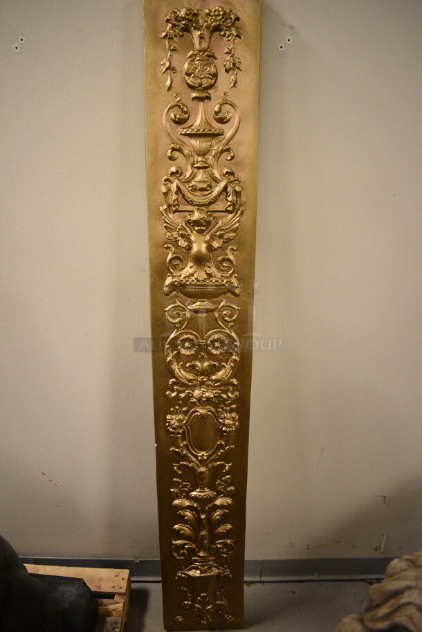 Gold Colored Wall Decor Piece With Baby and Fountain Etchings