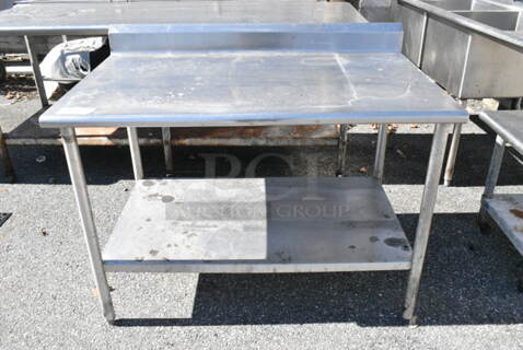 Stainless Steel Table w/ Metal Under Shelf and Back Splash. (out back)