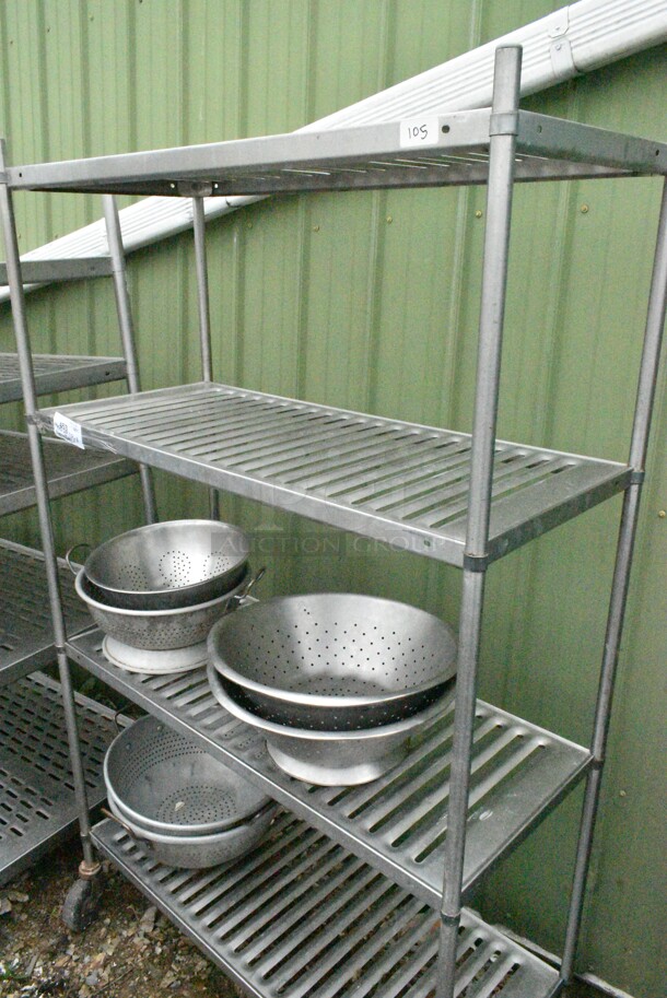 Metal 4 Tier Shelving Unit w/ Contents Including Colanders. BUYER MUST DISMANTLE. PCI CANNOT DISMANTLE FOR SHIPPING. PLEASE CONSIDER FREIGHT CHARGES.
 - Image 1 of 9