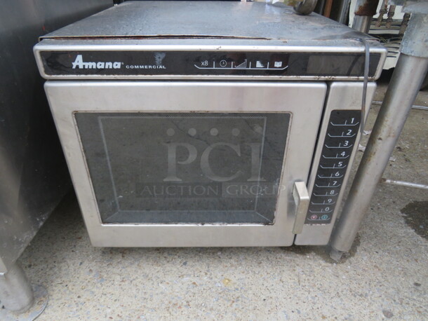 One Amana Microwave. 20X24X18 - Image 1 of 3