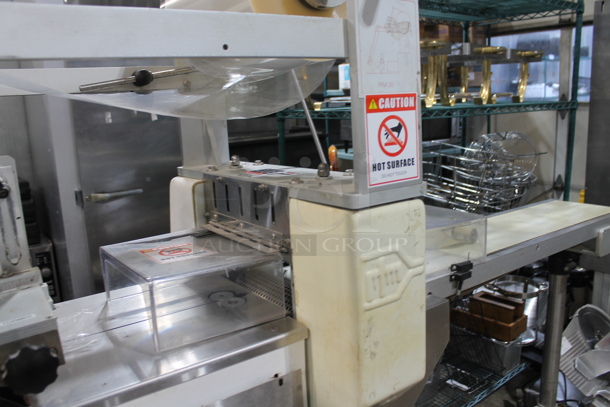 PFM Packaging 30 M Metal Commercial Floor Style Horizontal Form Fill and Seal / Horizontal Flow Wrapper Machine on Commercial Casters. 220 Volts, 1 Phase.  - Image 6 of 11