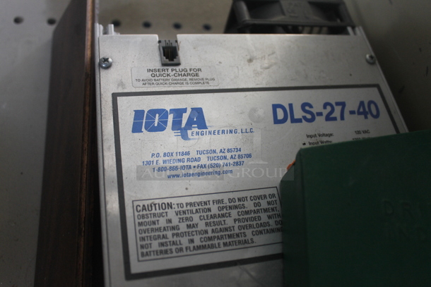 Gray Metal 3 Tier Shelving Unit and Wooden Table w/ Contents Including Iota DLS-27-40 Battery Charger. BUYER MUST REMOVE. - Image 4 of 6