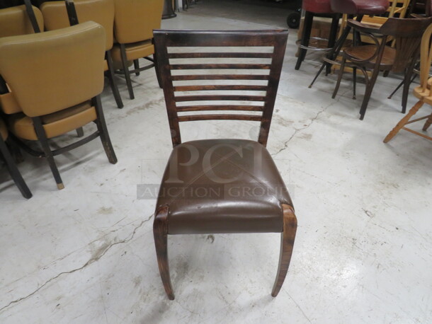 One Wooden Chair In A Dark Finish With A Brown Cushioned Seat.  - Image 1 of 3