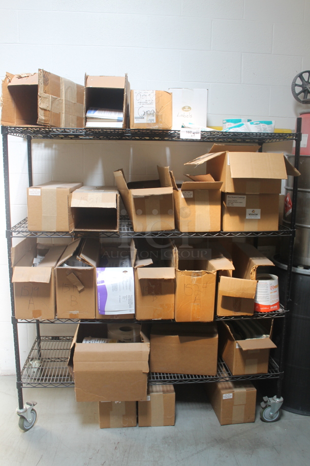 Black 4 Tier Wire Shelving Unit w/ Contents Including Labels on Commercial Casters. BUYER MUST REMOVE. - Image 1 of 7