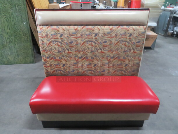 One Single Sided Booth With Red Cushioned Seat And Multi Color Back. 47X26X45.5