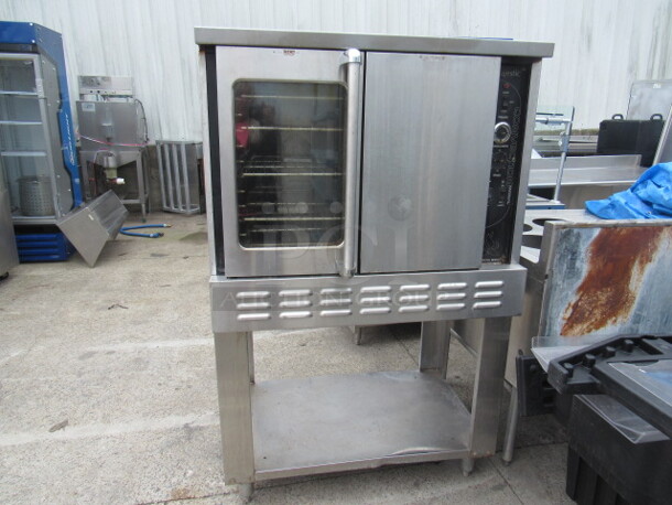 One Majestic American Range  Full Size Natural Gas Convection Oven With 4 Racks, On A SS Equipment Stand With Under Shelf, On Casters. Missing 1 Knob. 40X30X64