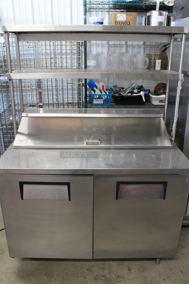 2011 True Model TSSU-48-12 Stainless Steel Commercial Sandwich Salad Prep Table Bain Marie Mega Top w/ 2 Tier Over Shelf on Commercial Casters. 115 Volts, 1 Phase. 49x29x69. Tested and Powers On But Temps at 45 Degrees