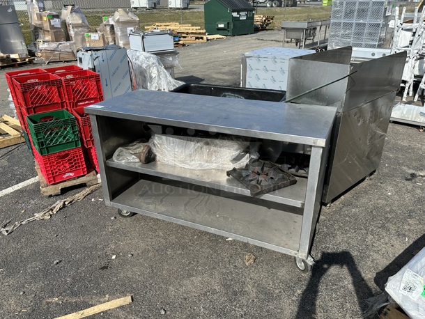 Stainless Steel Commercial Table w/ 2 Under Shelves on Commercial Casters. Does Not Come w/ Contents.