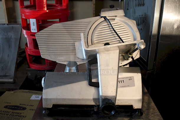 DO NOT PASS THIS BY! Univex 7512 Manual Meat & Cheese Slicer w/ 12" Blade In OUTSTANDINGLY GOOD CONDITION!! Belt Driven, Aluminum, 1/2 hp, WORKING! 120v/20hz/1phase 25"x21-1/2x20-3/4 87lbs - Image 1 of 6