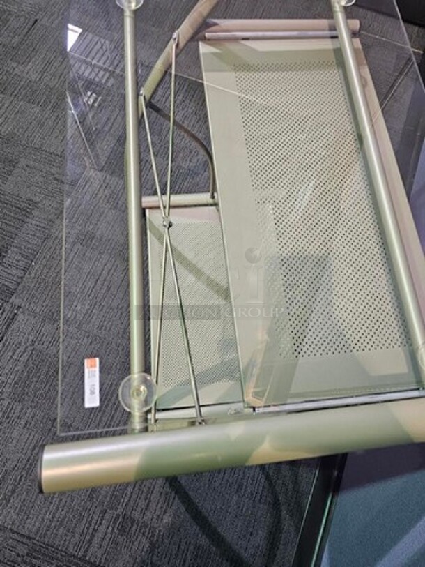 Metal silver rolling small desk with glass top. In good condition! Minor wear and scratches but cleans up very nicely and is fully functional. 27” W x 29” H x 19” D.  - Image 3 of 3