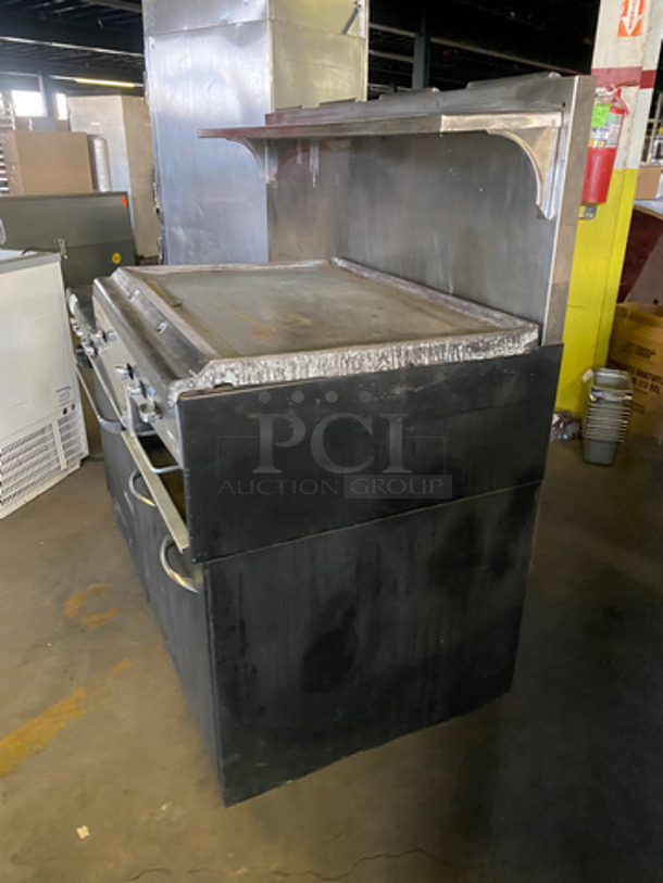 Commercial Natural Gas Powered 4 Burner Stove! With Built In Flat Top Grill! With Back Splash And Salamander Shelf! With Full Size Oven! Metal Oven Rack! With 2 Door Storage Area Underneath! All Stainless Steel! - Image 2 of 12