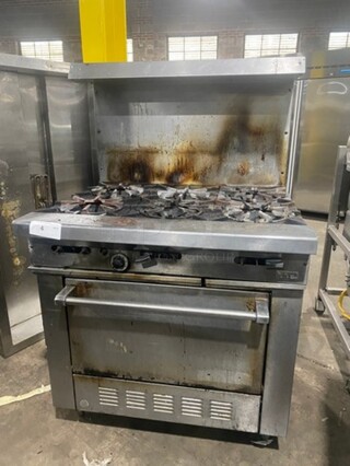 Garland Commercial Natural Gas Powered 6 Burner Stove! With Raised Back Splash And Salamander Shelf! With Oven Underneath! All Stainless Steel! On Legs!