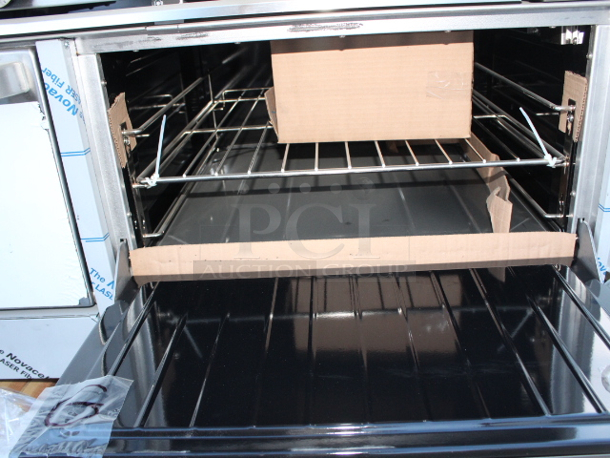 BRAND NEW SCRATCH & DENT! Garland G60-4G36RR Natural Gas 4 Burner 60" Range with 36" Griddle and 2 Standard Ovens - 262,000 BTU. S/N: 2310100102544 Rail holding burners is bent, Splash Guard is bent, 1 knob not connected. (see photos)	 - Image 6 of 9