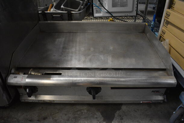 APW Wyott Stainless Steel Commercial Countertop Propane Gas Powered Flat Top Griddle w/ Thermostatic Controls. 36x25.5x16