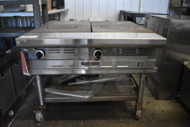 BRAND NEW SCRATCH AND DENT! Garland Stainless Steel Commercial Gas Powered 2 Burner Range on Stainless Steel Commercial Equipment Stand w/ Commercial Casters. 115 Volts, 1 Phase. 34x39x27