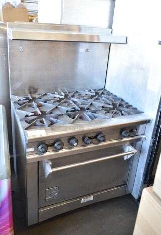 Wolf Stainless Steel Commercial Natural Gas Powered 6 Burner Range w/ Oven, Back Splash and Over Shelf on Commercial Casters. 