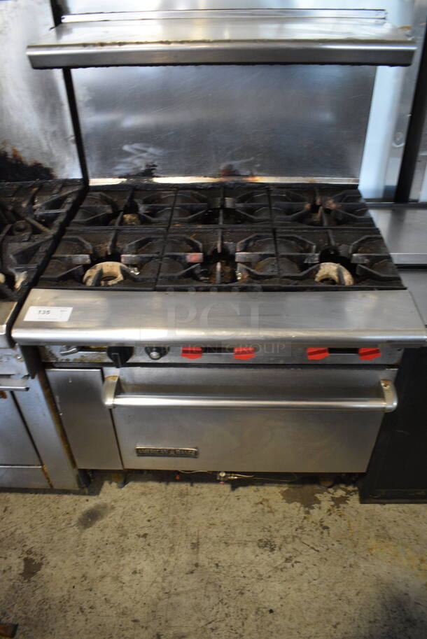American Range Commercial Stainless Steel Natural Gas 6 Range Burner With Overshelf And Oven With Metal Racks on Galvanized Legs.