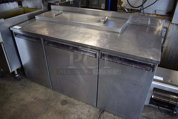 Delfield Stainless Steel Commercial 3 Door Prep Table w/ Back Splash. 60x30.5x34. Tested and Powers On But Temps at 50 Degrees