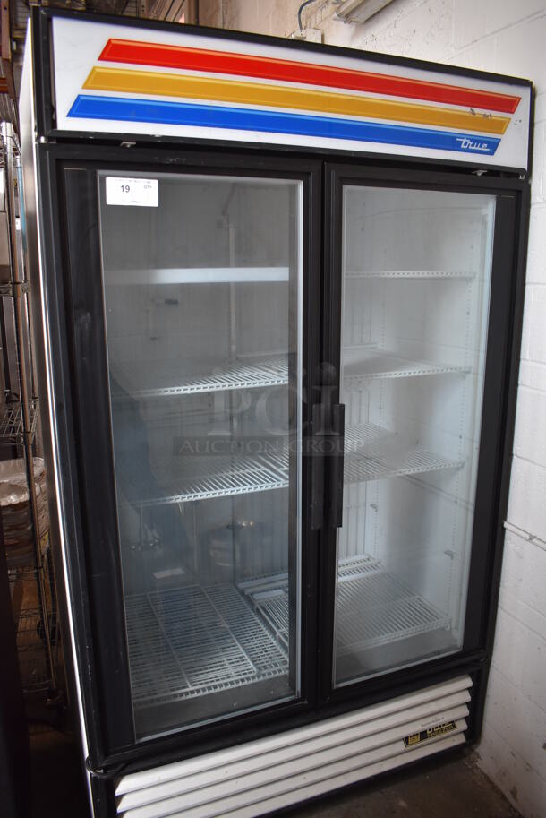 True GDM-43F Metal Commercial 2 Door Reach In Freezer Merchandiser w/ Poly Coated Racks and Sliding Doors on Commercial Casters. 115/208-230 Volts, 1 Phase