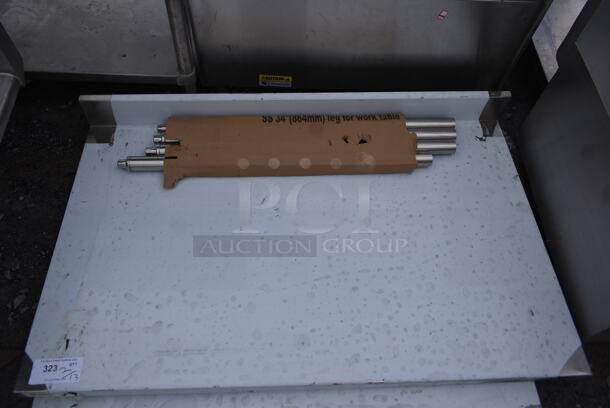 BRAND NEW SCRATCH AND DENT! Regency 600TSB3048S 30" x 48" 16-Gauge Stainless Steel Commercial Work Table with 4" Backsplash and Undershelf - Image 3 of 6
