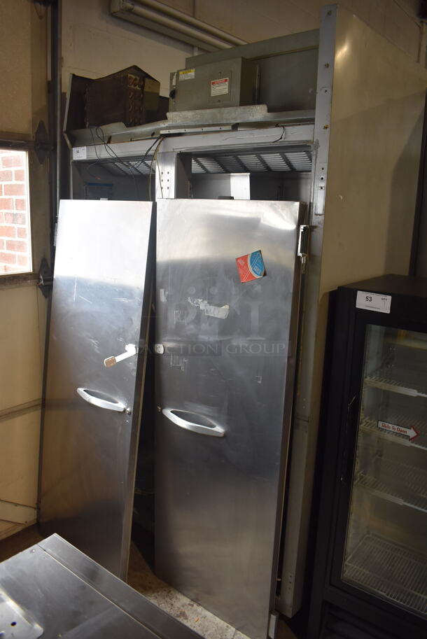 Beverage-Air ER48-1AS Commercial Stainless Steel Two-Section Solid Door Reach-In Cooler With Racks on Commercial Casters. Doors Need Reattached. 115V/1 Phase Tested And Powers On But Does Not Get Cold