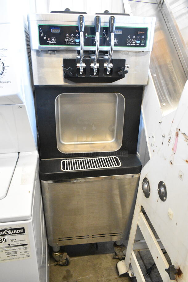 Wellspring Model SSI-143S Stainless Steel Commercial Floor Style Air Cooled 2 Flavor w/ Twist Soft Serve Ice Cream Machine on Commercial Casters. 220 Volts, 1 Phase.  - Image 1 of 7