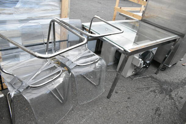 Metal Table w/ 4 Clear Poly and Metal Chairs.  - Image 1 of 5
