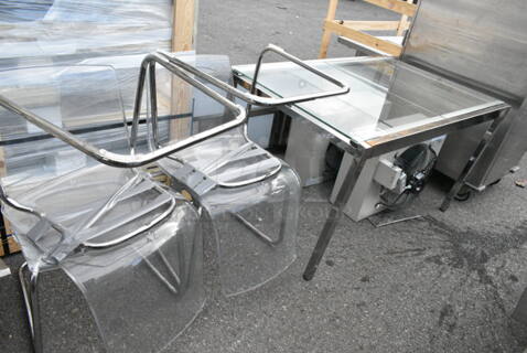 Metal Table w/ 4 Clear Poly and Metal Chairs. 