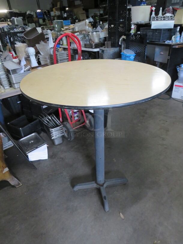 One Light Oak Color Round Table Top On A Bar Height Pedestal Base. 36X42 - Image 1 of 2