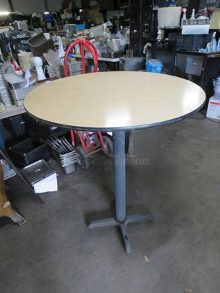 One Light Oak Color Round Table Top On A Bar Height Pedestal Base. 36X42
