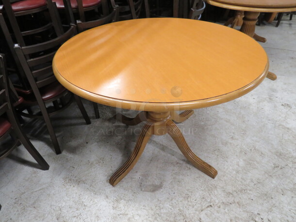 One 42 Inch Round Solid Wooden Table With A Wooden Base. 42X42X30.