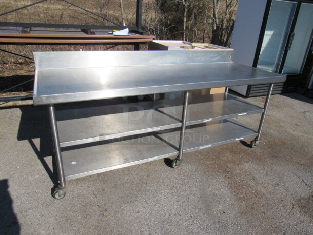 One Stainless Steel Table With 2 Stainless Steel Under Shelves, Back Splash, On Casters. 90X32X40