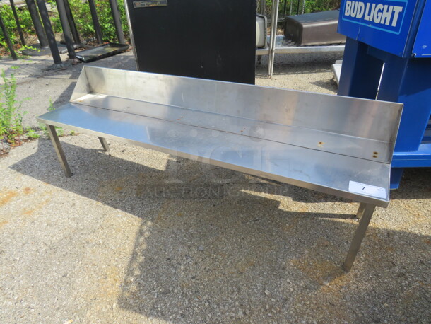 One Stainless Steel Shelf With Back Splash On Legs. 60X14X25