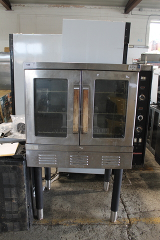 Vulcan Stainless Steel Commercial Propane Gas Powered Full Size Convection Oven w/ View Through Doors, Metal Oven Racks and Thermostatic Controls on Metal Legs.