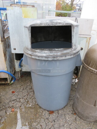 One Rubbermaid Brute Trash Can With A Dome Lid.
