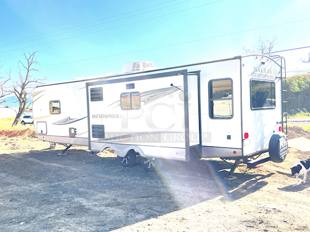 ? 2021 Forest River Salem Hemisphere 271RL-W 34ft 7in Travel Trailer With Upgraded Options Package & VIP Package. ? Includes All Original Paper Work. In LIKE NEW CONDITION minus a scratched piece of flooring on the kitchen side by the push out (see Photos).

MORE PHOTOS ON NUMBER 420 - Video on our Facebook Page: PCI Auctions West Coast
TRAVEL TRAILERS STANDARD FEATURES
• Extra Large Pass Thru Storage
• Versa Queen in Bunk Slides Standard
• European Oak colored horizontal plank linoleum Flooring
• Outside Kitchen Standard (270FKS, 273RL, 310BHI, 314BUD)
• Saddle colored wood cabinetry w/ matte black hardware
• Side-Mounted Heat Ducts
• Pantry Doors w/ Glass Inserts & Motion Sensor Pantry Lights
• Stackable Washer/Dryer Prep Std. on 270FKS, 308RL, 310BHI
• 7-Way “Rain Defense” Plug Holder (Front Frame)
• Wide Stance Axle System
• 2-Tone Painted Fiberglass Front Cap with Automotive Windshield
(N/A Windshield 308RL)
• Hidden Hinges on Cabinet Doors
• 50 Amp Service Standard
• 10 CU FT Black Refrigerator (12V)
• Laminated “Aluma Frame” Sidewalls and Floor with Block
Foam Insulation
• Heated & Enclosed Underbelly
• Radial Tires with Black-Accented Aluminum Rims
• Interior Grab Handle at Entry Door
• Shaded Pet Tether/Security Hook
• LED-Lit Theater Seating with Recliners (Most Models) • Designer’s Choice Luxury Comforter
• Exterior Bottle Opener

UPGRADED OPTIONS PACKAGE (INCLUDED)
• High Rise Faucet with Pull-Out Sprayer
• Spare Tire & Carrier
• Outside Shower
• 15,000 BTU A/C Ducted with Quick Cool
• Ivory Performance Colored Exterior Fibererglass with
Smoked Quartz Metallic Accents • Central Switch Center
• Solar Prep
• Lippert “On The Go” Ladder Prep • LP Quick Connect
• Extra Wide 30” Entrance Door
• Tri-Fold Sleeper Sofa or Theater Sofa

VIP PACKAGE (INCLUDED)
• Extra Large Max-Tint Panoramic Window Package
• 12V Heat Pads on All Holding Tanks
• Recessed Glass Stove Top Cover
• Midnight Glass Range Hood
• Midnight Glass Microwave
• Back Up Camera Prep
• Step Above Aluminum Entry Steps (Main Entry Door)
• 50” LED TV & Furrion Soundbar with FM, Bluetooth, HDMI, & USB • Stainless Steel, Single Bowl Undermount Sink with Roll Up
Sink Cover
• Power Stabilizer and Tongue Jacks
• Friction Door Hinge
• Baggage Door Magnets and Easy Pull Slam Latches
• LED Awning, Front Cap, Marker and Tail Lights
• 31” Glass Mirror Front Electric Fireplace
• Porcelain Toilet - Image 3 of 12