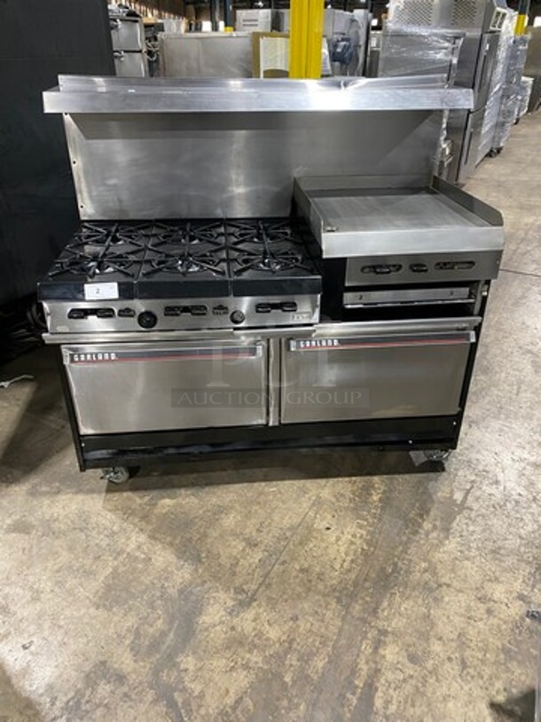 GREAT FIND! Garland Commercial Gas Powered 6 Burner Stove With Right Side Flat Griddle! Griddle Has Side Splashes! With Raised Back Splash And Salamander Shelf! With 2 Oven Underneath! Metal Oven Racks! All Stainless Steel! On Casters! Working When Removed!