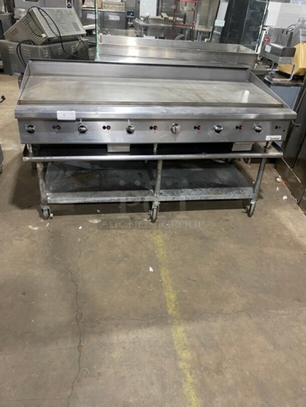 NICE! Garland Heavy Duty Commercial Countertop Gas Powered Flat Griddle! 1-Inch-Thick Plate! With Back And Side Splashes! On Equipment Stand! With Storage Space Underneath! All Stainless Steel! Model GTGG72G72M Serial 1303100100266! On Casters! WORKING WHEN REMOVED!