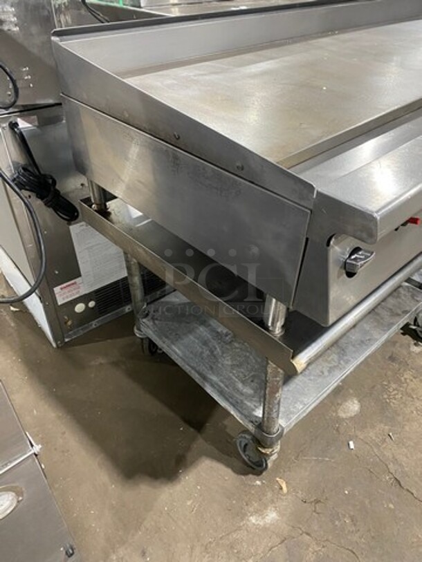 NICE! Garland Heavy Duty Commercial Countertop Gas Powered Flat Griddle! 1-Inch-Thick Plate! With Back And Side Splashes! On Equipment Stand! With Storage Space Underneath! All Stainless Steel! Model GTGG72G72M Serial 1303100100266! On Casters! WORKING WHEN REMOVED! - Image 2 of 9