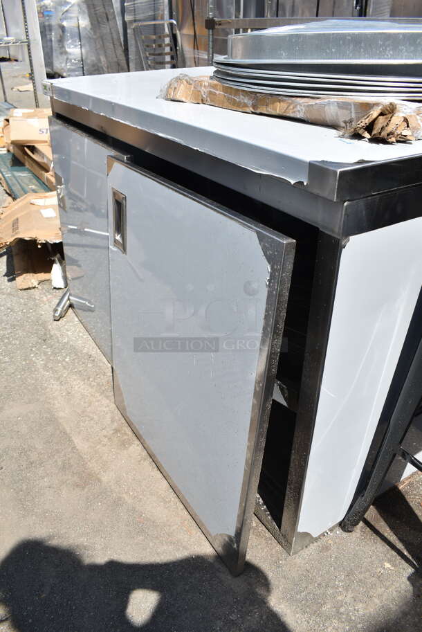 BRAND NEW SCRATCH AND DENT! Regency 600EBT3048D 30" x 48" 16 Gauge Type 304 Stainless Steel Enclosed Base Table with Sliding Doors and Adjustable Midshelf - Image 3 of 7