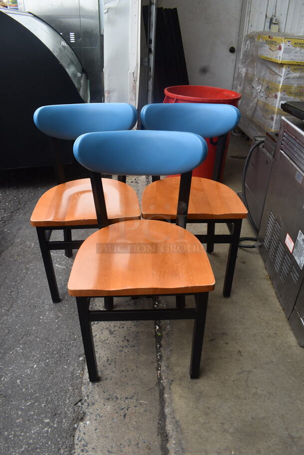 3 Dining Chairs with Blue Padded Backs, Wood Seat and Black Metal Frame. Stock Picture - Cosmetic Condition May Vary. 3 Times Your Bid!
