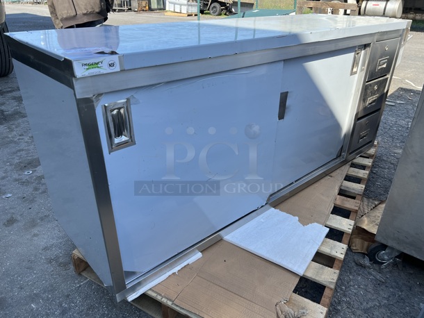 BRAND NEW SCRATCH AND DENT! Regency 600EBT2472R Stainless Steel Commercial 24" x 72" 16 Gauge Type 304 Enclosed Base Sliding Door Table with Drawers - Image 1 of 10