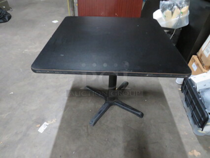 One Black Laminate Table Top On A Pedestal Base. 36X36X29
