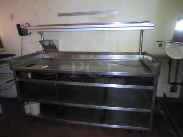 One Stainless Steel Table With 3 Stainless UnderShelves, Stainless Steel Over Shelf With Ticket Rail, R/L And Back Splash On Casters. Buyer MUST REMOVE! 75X30.5X60